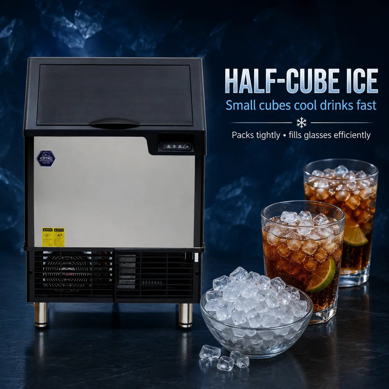 A countertop ice machine with a brushed silver front panel and black top, side, and lower grille, shown on a dark blue background with promotional text reading 'HALF-CUBE ICE' and two glasses of iced drink plus a bowl of ice cubes.