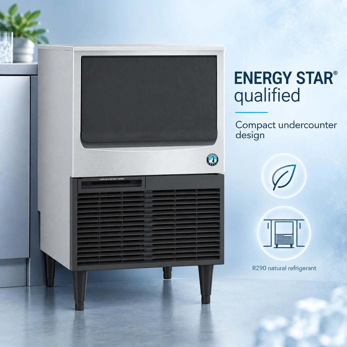 A compact stainless steel and black undercounter ice machine shown in a clean studio-style setting with promotional text on the right reading 'ENERGY STAR qualified' and 'Compact undercounter design.' No person or animal is present, so this is Product/Packaging rather than Lifestyle.