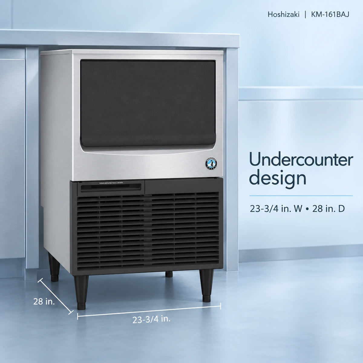 Undercounter ice machine in stainless steel and black, shown in a clean blue-toned kitchen or storage environment with dimension labels and text reading 'Undercounter design' and '23-3/4 in. W + 28 in.