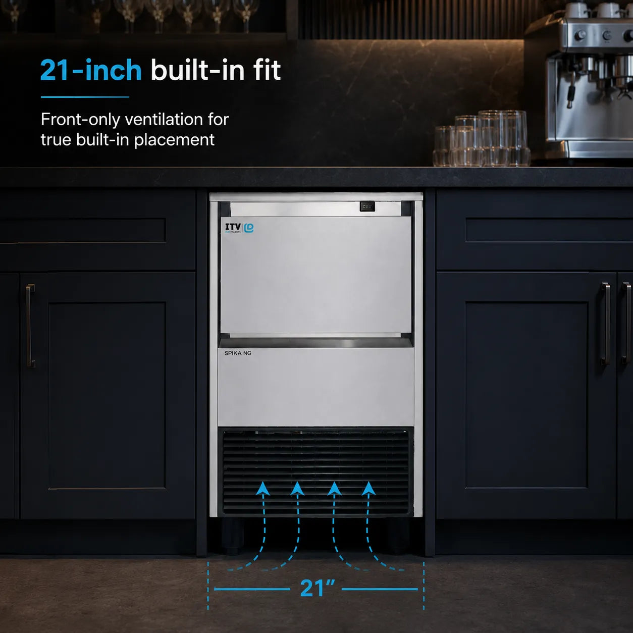 A built-in ice machine shown installed under a dark countertop in a kitchen-like setting. The product is a stainless steel front-cooled ice maker with blue ventilation arrows and text indicating a 21-inch built-in fit.