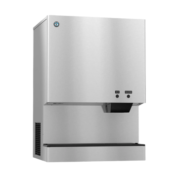 A stainless steel commercial ice machine with a brushed metal finish, featuring a black drip tray, a small control panel with buttons, and a vent on the side, shown against a plain white background.