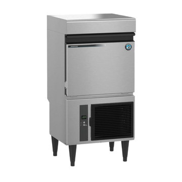 A commercial countertop ice machine with a brushed stainless steel body, black front trim, black legs, and a black vented condenser panel on the lower section, shown on a plain white background.