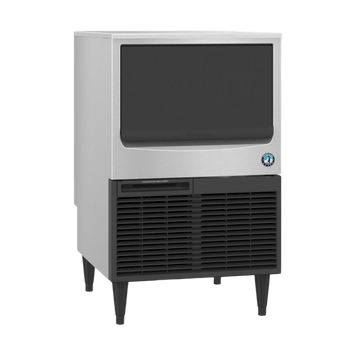 A commercial ice machine with a brushed silver metal front, a large black ice compartment window, a black vented lower section, and dark legs, shown on a plain white background.