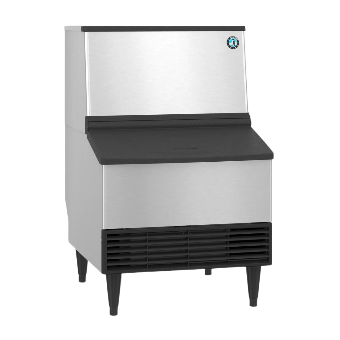 A commercial ice machine with a brushed stainless steel body, black top and front apron, black legs, and a small circular blue logo badge on the upper right front panel, shown on a plain white background.