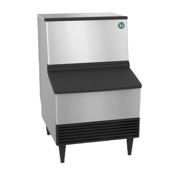 A commercial ice machine with a brushed stainless steel body and black plastic components, including the top lid, front chute, legs, and vent grille, shown on a plain white background.