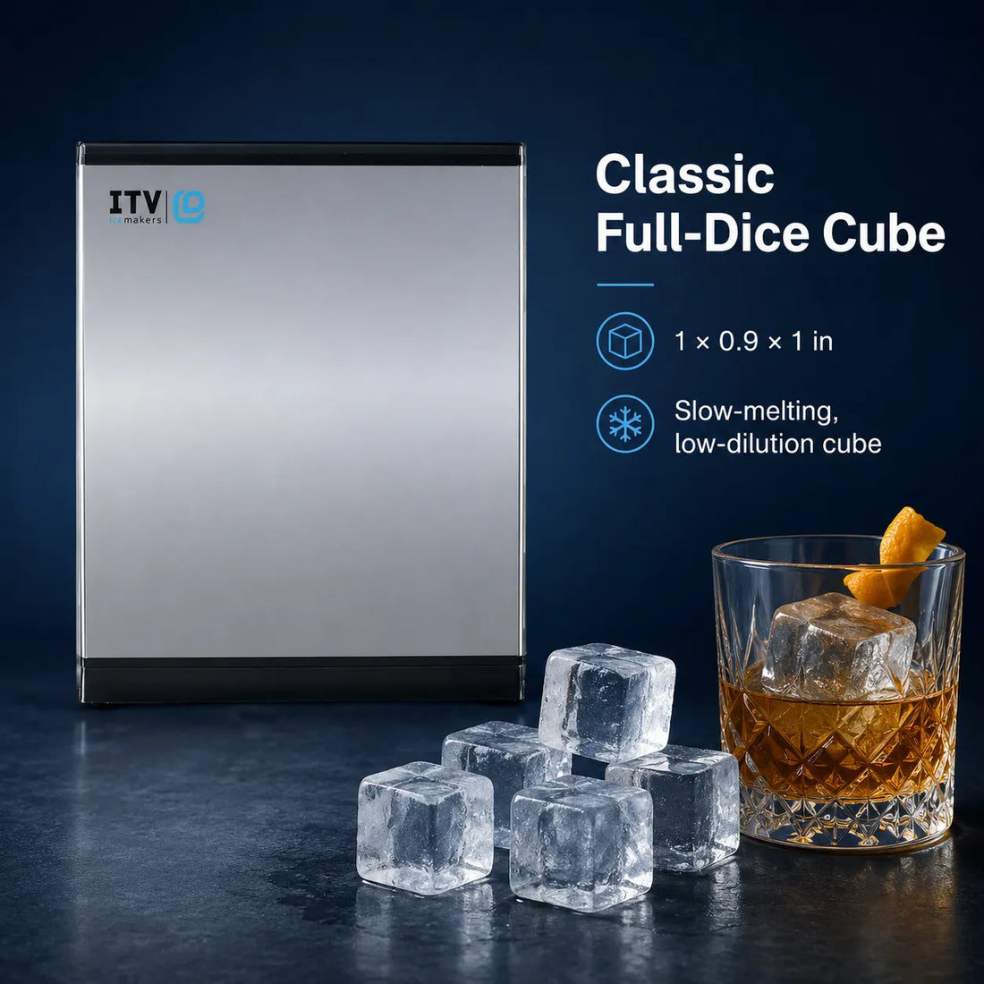 A stainless steel countertop ice maker shown next to several clear full-dice ice cubes and a glass of whiskey with an orange peel garnish. Text on the right reads 'Classic Full-Dice Cube' with dimensions and feature callouts.