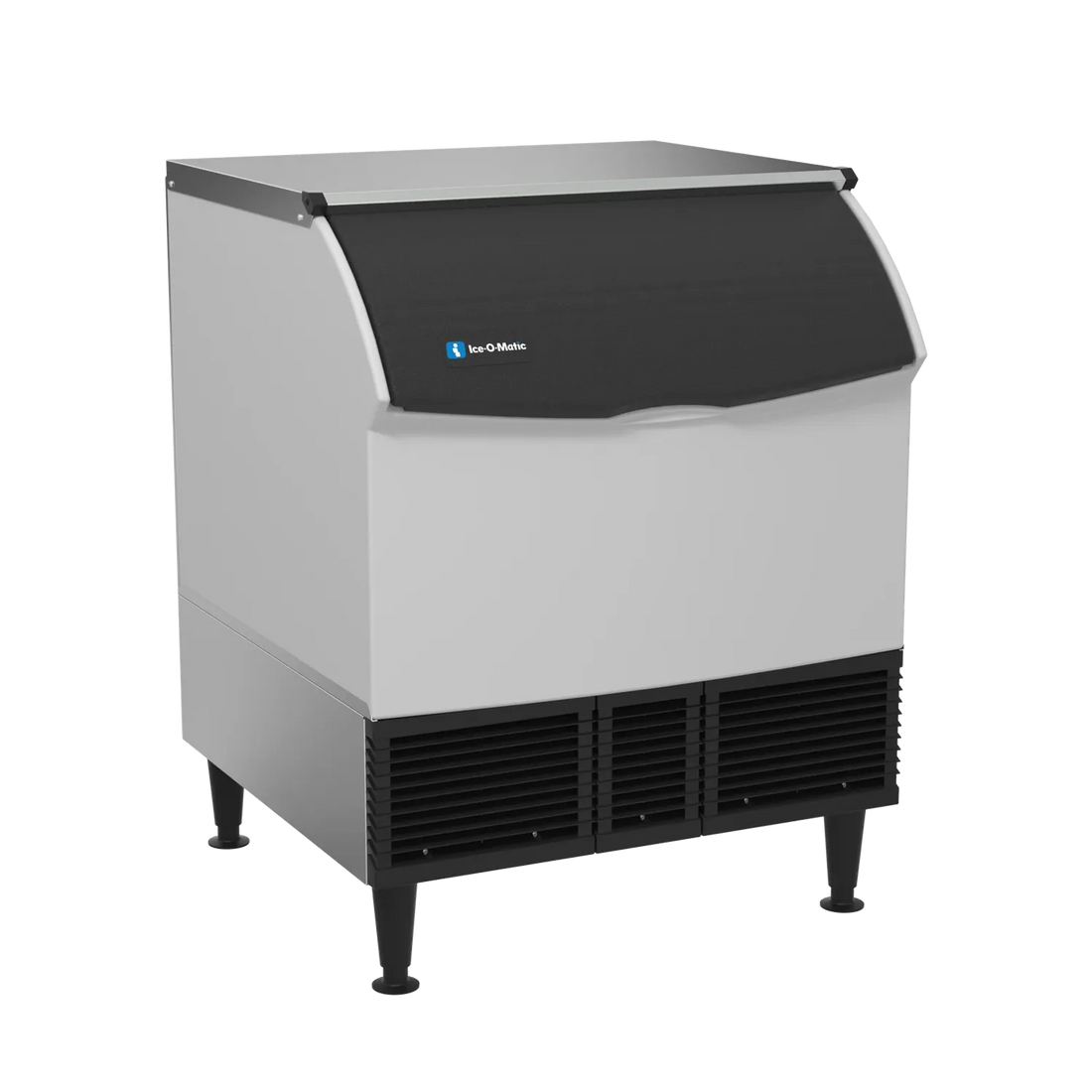 A commercial ice machine with a white body, a black curved top lid, black legs, and black ventilation grilles on the bottom front. The brand name 'ba-CHileans' is visible in blue on the front upper section.